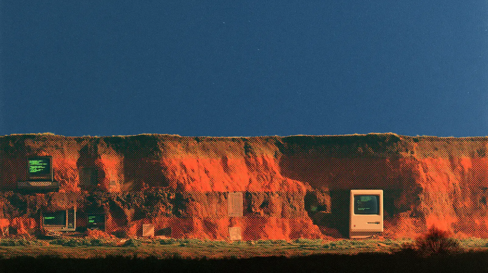 Halftone print illustration of an excavated cliff face beneath a deep blue sky. A vintage desktop computer and older terminals lie embedded in the sunlit orange strata like fossils; a dark field runs along the base.